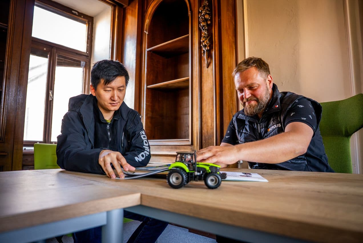 Zoomlion delegate and Kerouš representative reviewing the Zoomlion tractor lineup
